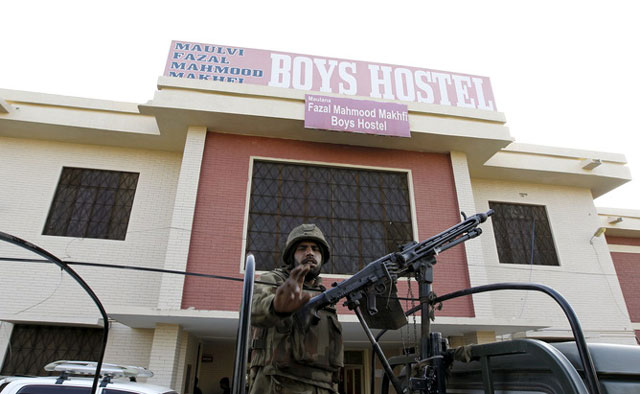 an army soldier stands guard at the entrance to a dormitory at the bacha khan university in charsadda khyber pakhtunkhwa photo reuters