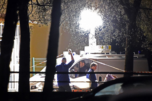 police evacuate a body after three men were shot and killed in marseille southern france on april 03 2016 three men were killed in a suspected gang shooting in southern france on april 2 2016 sources said taking to eight the number who have died in gang violence in the city this year part of a growing number of gang related murders in the city photo afp