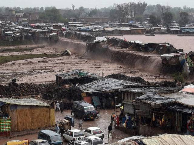 flood waters rush through a market area as vendors and resident scramble to save their possessions on the outskirts of peshawar on april 3 2016 photo afp flood waters rush through a market area as vendors and resident scramble to save their possessions on the outskirts of peshawar on april 3 2016 photo afp