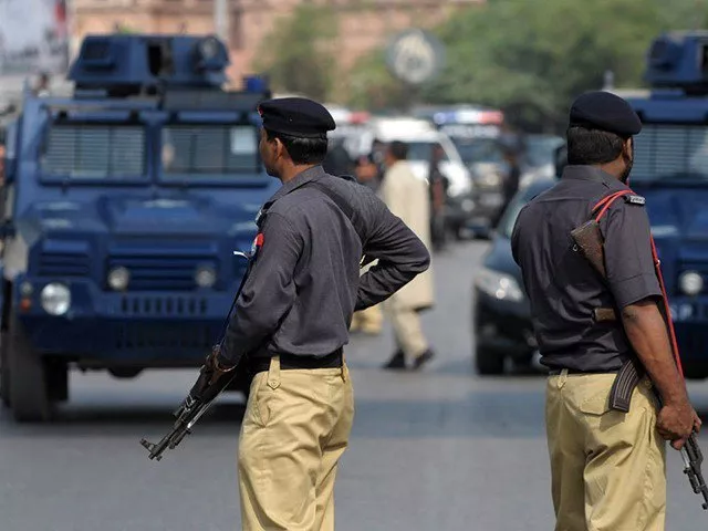 a minor girl was also injured when unidentified persons opened fire on a police mobile near nagan chowrangi photo afp a minor girl was also injured when unidentified persons opened fire on a police mobile near nagan chowrangi photo afp