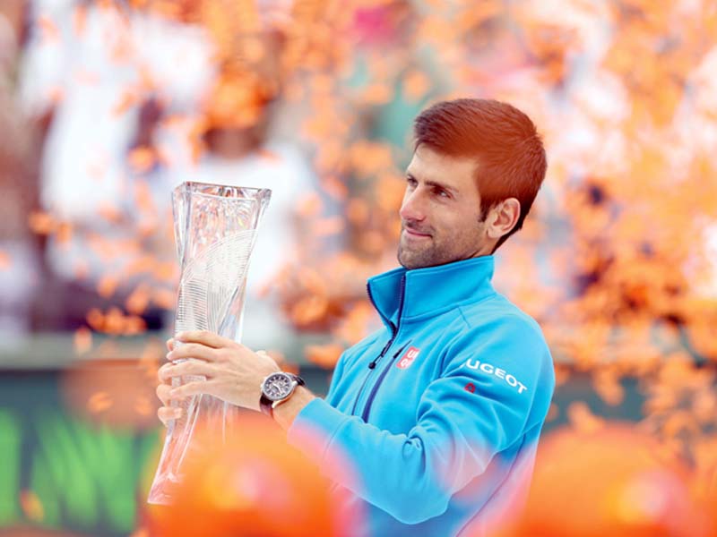 djokovic holds aloft the miami open trophy following his straight set victory over nishikori in the men s final photo afp