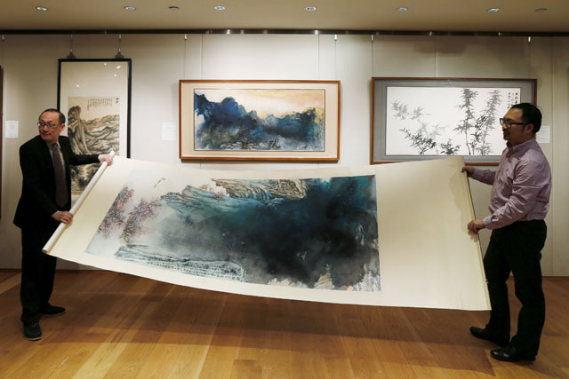 an inkbrush painting by late chinese artist zhang daqian called quot peach blossom spring quot is rolled during a preview at sotheby 039 s in hong kong china in this march 10 2016 file photo photo reuters
