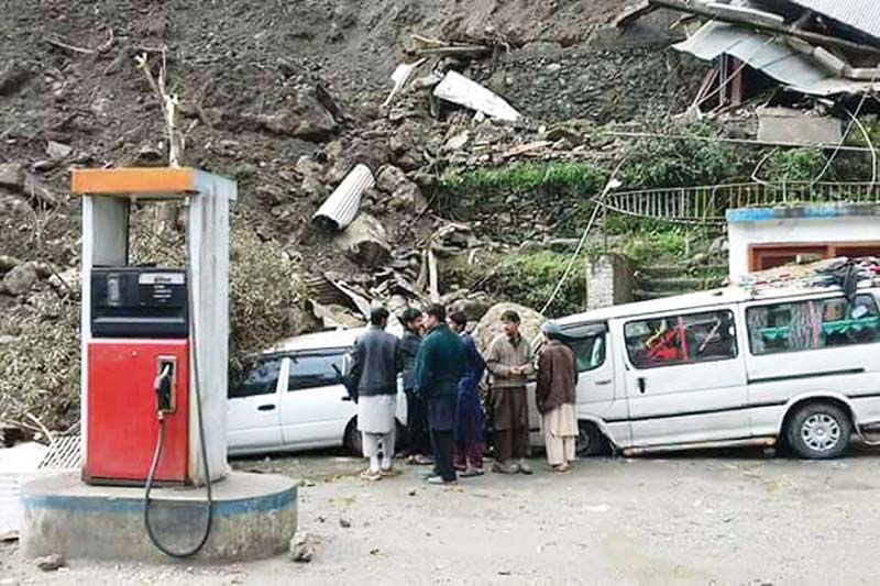 locals gather a petrol station in kohistan where vehicles were damaged by landslides photo online