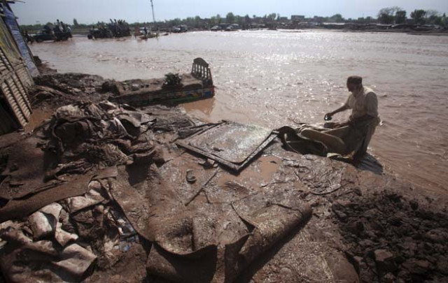 a man salvages his belongings from floodwaters in the sarband area on the outskirts of peshawar pakistan april 6 2016 photo reuters a man salvages his belongings from floodwaters in the sarband area on the outskirts of peshawar pakistan april 6 2016 photo reuters