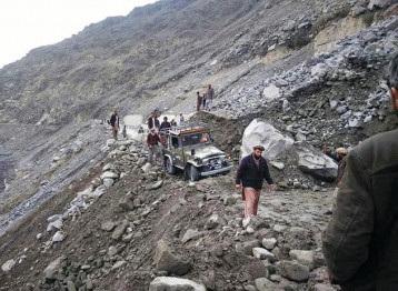 a massive landslide has blocked this road near chilas forcing people to walk to their destinations photo online