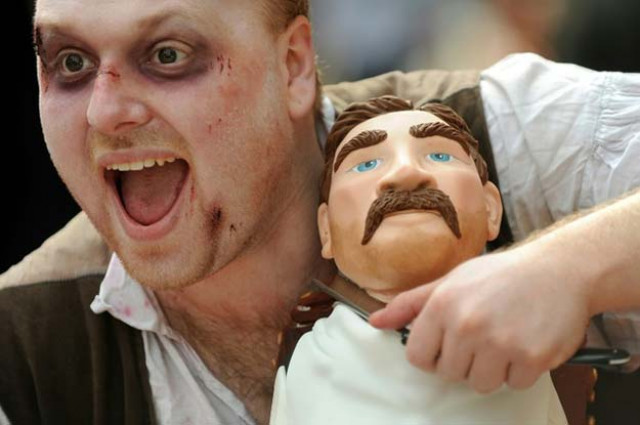 a london dungeon actor portraying sweeney todd cuts the throat of an effigy of a barber chair victimphoto afp
