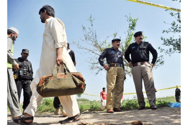 police personnel examining the scene after a police van was attacked photo inp police personnel examining the scene after a police van was attacked photo inp
