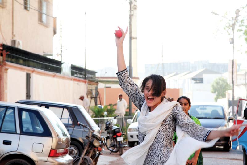 a girl catches the ball while fielding during a street cricket match on a street in nazimabad no 4 the street is dominated by girls playing different sports photo aysha saleem express