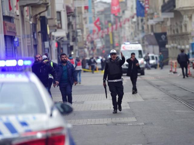 turkish police push people away just after an explosion on the pedestrian istiklal avenue in istanbul on march 19 2016 photo afp