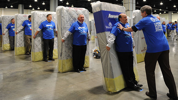 participants seen waiting for their turn to make a soft landing to make the largest human mattress dominoes record photo guinness world record