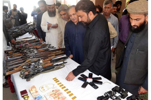 home minister mir sarfraz bugti checking weapons and items recovered by security forces during operation in the area of kalat photo online home minister mir sarfraz bugti checking weapons and items recovered by security forces during operation in the area of kalat photo online