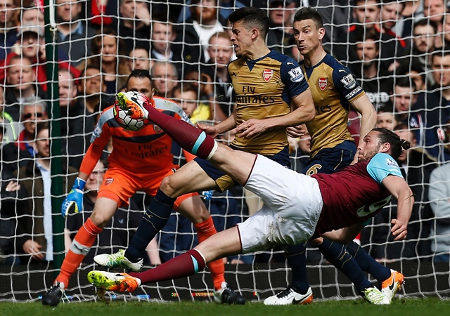 andy carroll shoots to score his team 039 s second goal against arsenal at the boleyn ground in upton park london on april 9 2016 photo afp