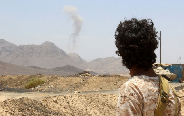 a yemeni fighter loyal to exiled president abedrabbo mansour hadi looks at smoke rising in the distance in the sirwah area in marib province on april 10 2016 photo afp a yemeni fighter loyal to exiled president abedrabbo mansour hadi looks at smoke rising in the distance in the sirwah area in marib province on april 10 2016 photo afp