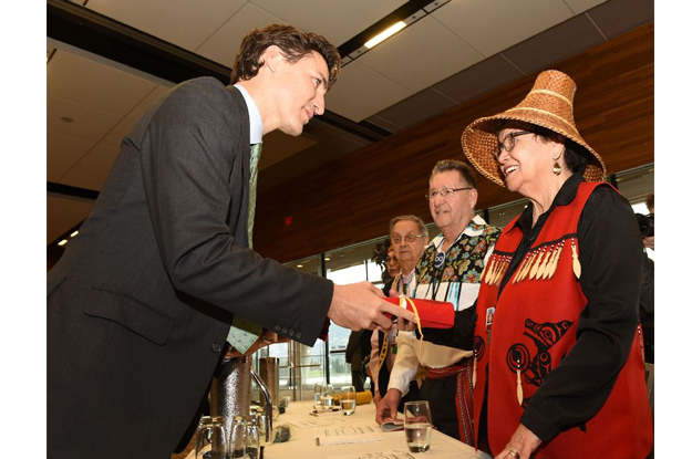 prime minister justin trudeau gives a gift to aboriginal elders that blessed the opening of the first ministers meeting in vancouver on march 2 2016 photo afp file