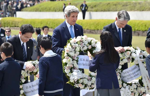 us secretary of state john kerry c japan 039 s foreign minister fumio kishida r and british foreign secretary philip hammond receive wreaths to offer at the memorial cenotaph for the 1945 atomic bombing victims in the peace memorial park on the sidelines of the g7 foreign ministers 039 meeting in hiroshima on april 11 2016 photo afp