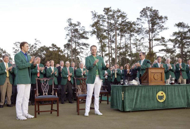 willett c celebrates after being presented with the green jacket which goes to the winner of the masters by defending champion spieth l photo afp