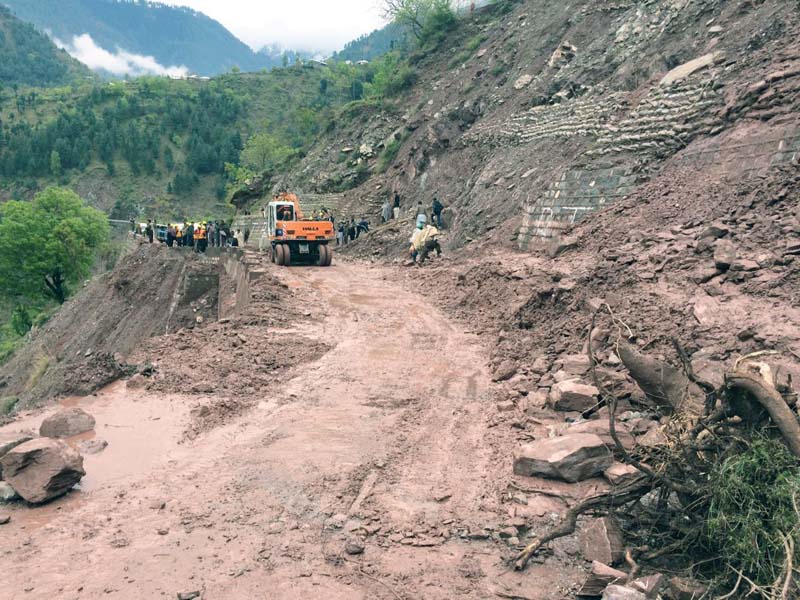 road workers use excavators to clear debris from landslides in balakot after sunday s massive earthquake photo express