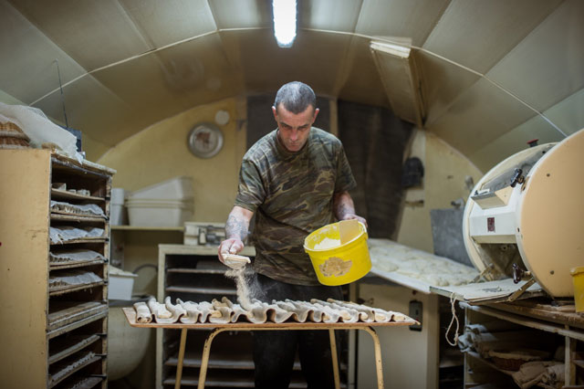 this file photo taken on march 23 2016 shows jerome a former homeless working in a bakery on march 23 2016 in dole eastern france michel flamant the owner of the bakery decided to teach baking and pastry to jerome and to sell him his bakery for one symbolic euro after jerome saved his life photo afp