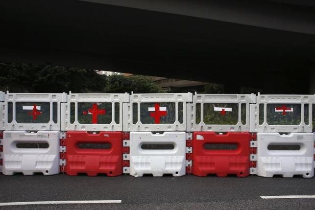 red cross signs are seen on road blocks used by protesters to set up a makeshift first aid station at the financial central district in hong kong on september 30 2014 photo reuters