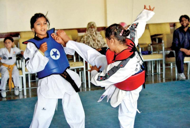 girls compete in taekwondo match during the event photo inp girls compete in taekwondo match during the event photo inp