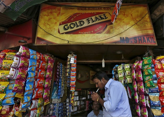 a man lights a cigarette in front of a kiosk in kolkata india april 7 2016 photo reuters a man lights a cigarette in front of a kiosk in kolkata india april 7 2016 photo reuters