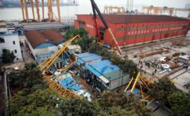 the crane fell onto a building made of shipping containers photo afp the crane fell onto a building made of shipping containers photo afp