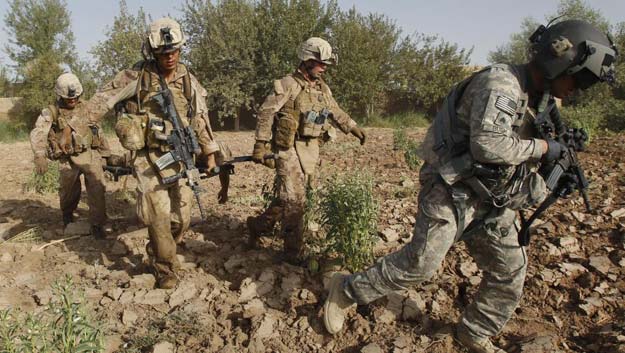 us marines carry a wounded comrade in afghanistan photo reuters