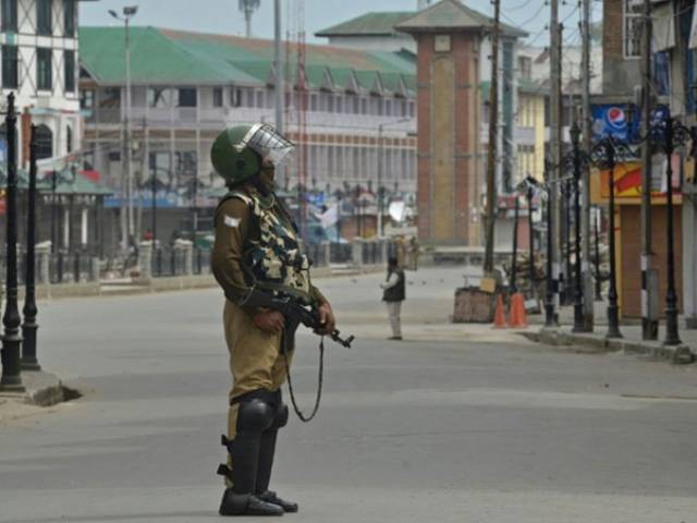 an indian paramilitary trooper stands guard during a tense curfew in srinagar photo afp