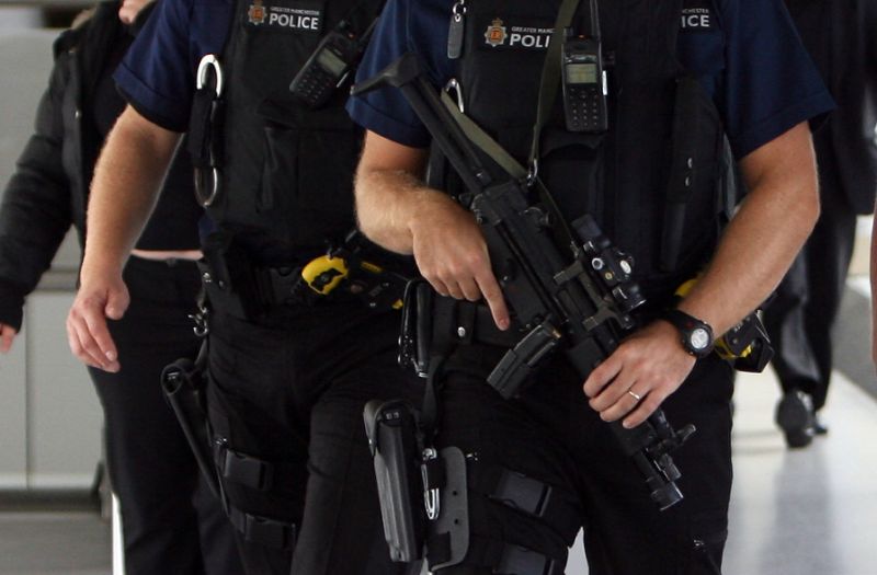 armed police officers patrol manchester airport on august 10 2006 photo afp