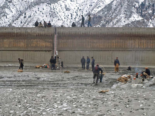people stand near the water reservoir in naltar photo express people stand near the water reservoir in naltar photo express