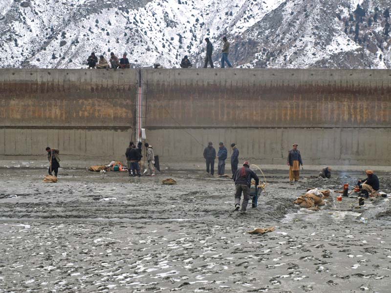 people stand near the water reservoir in naltar photo express
