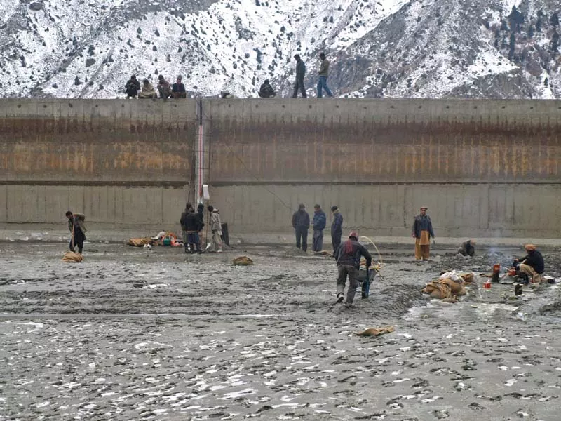 people stand near the water reservoir in naltar photo express people stand near the water reservoir in naltar photo express