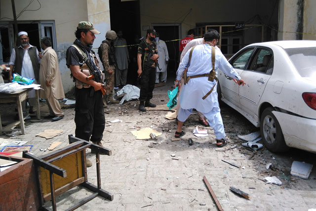 security officials inspect the site of a suicide bomb attack at mardan 039 s excise and taxation department on april 19 2016 photo afp