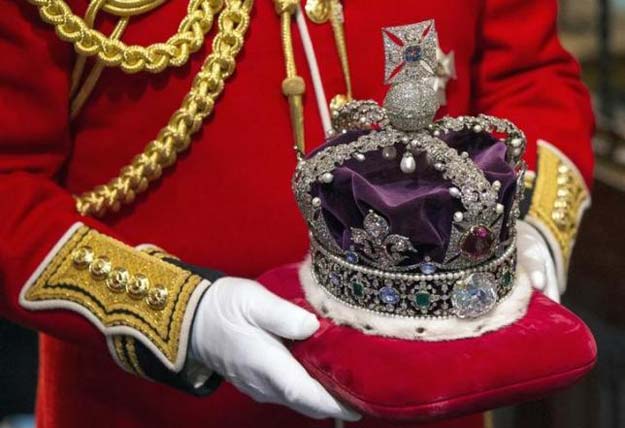 britain 039 s queen elizabeth 039 s crown is carried through the norman porch of the palace of westminster after the state opening of parliament on june 4 2014 in london england photo reuters