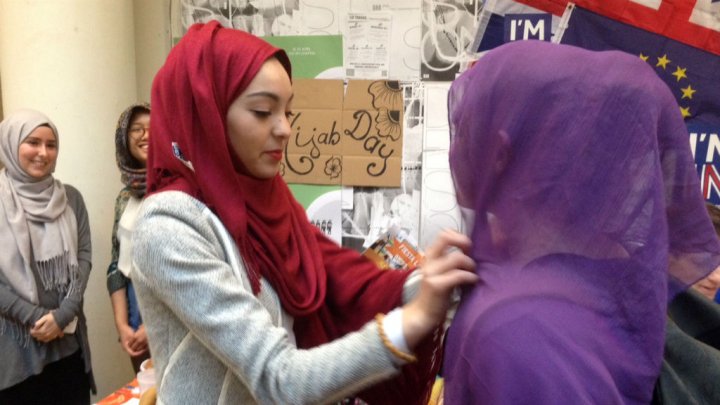 a sciences po university student tries on a muslim veil during the 039 hijab day 039 event on april 20 2016 photo courtesy france 24