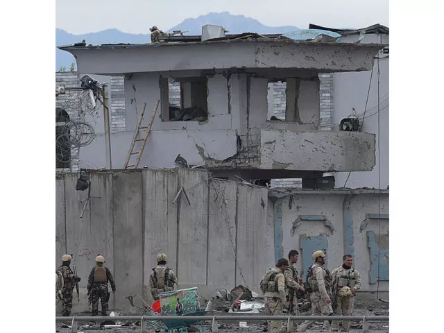 afghan security personnel inspect the site of a car bomb attack at the gate of a government office in the puli mahmood khan neighbourhood of kabul on april 19 2016 photo afp afghan security personnel inspect the site of a car bomb attack at the gate of a government office in the puli mahmood khan neighbourhood of kabul on april 19 2016 photo afp