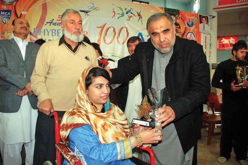 zainab receives an award after she won a competition photo express