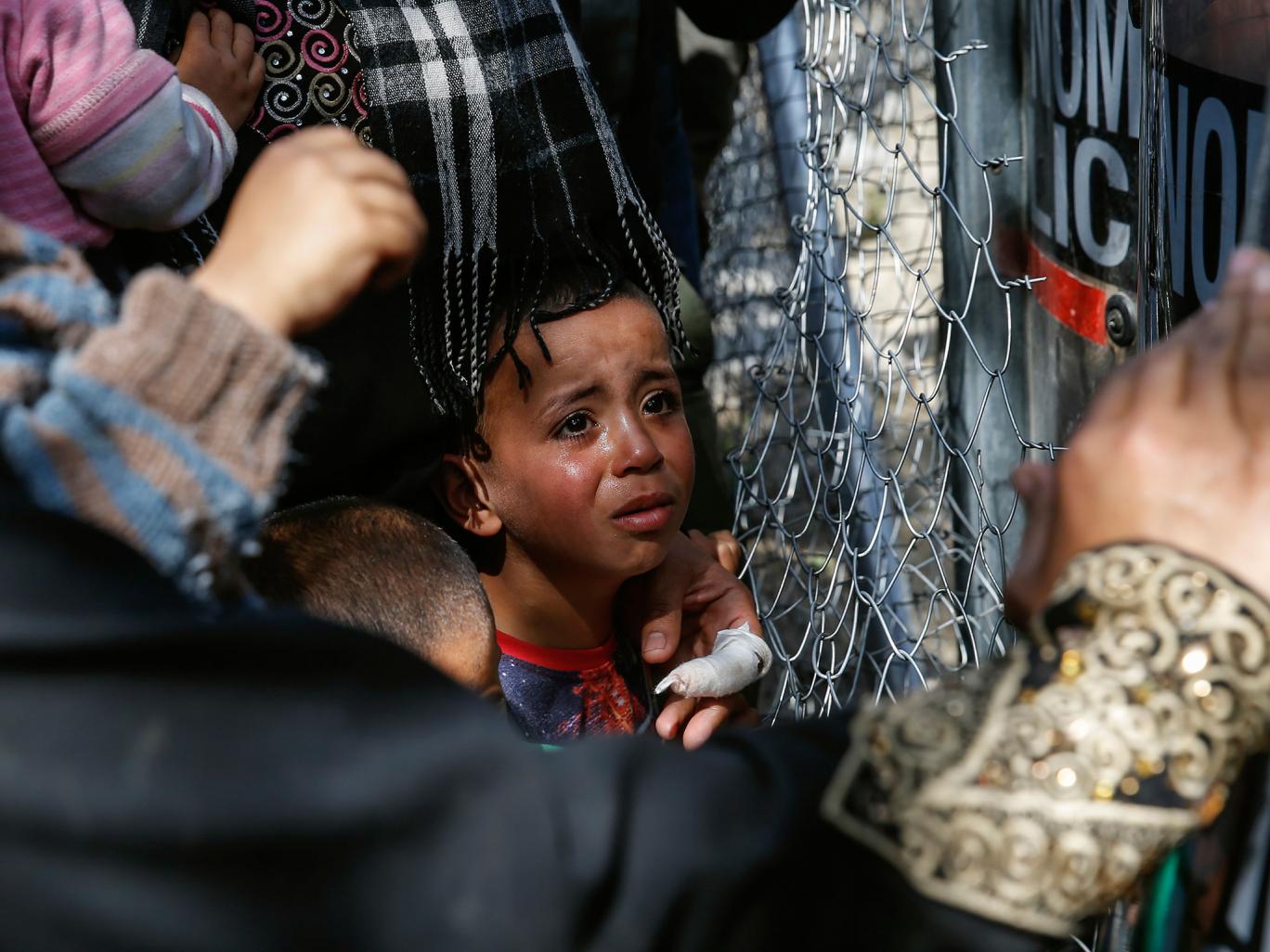a child cries as migrants and refugees clash with greek policemen as they try to open the border fence at a makeshift camp at the greek macedonian border near the village of idomeni greece april 7 2016 photo reuters