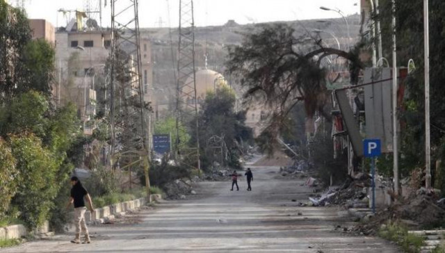 people walk along a damaged street in deir al zor eastern syria april 3 photo reuters people walk along a damaged street in deir al zor eastern syria april 3 photo reuters