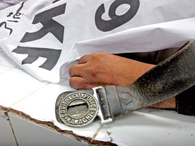 the body of one of the policemen slain in the attack in orangi town photo athar khan express