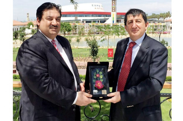 commerce minister khurram dastgir is presented with a souvenir by the commissioner general of antalya horticulture expo photo nni commerce minister khurram dastgir is presented with a souvenir by the commissioner general of antalya horticulture expo photo nni