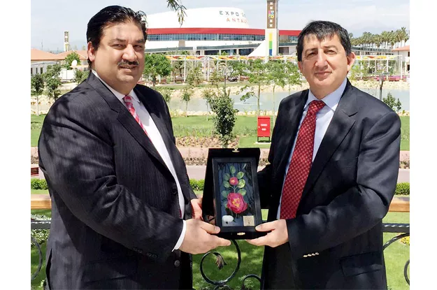 commerce minister khurram dastgir is presented with a souvenir by the commissioner general of antalya horticulture expo photo nni commerce minister khurram dastgir is presented with a souvenir by the commissioner general of antalya horticulture expo photo nni