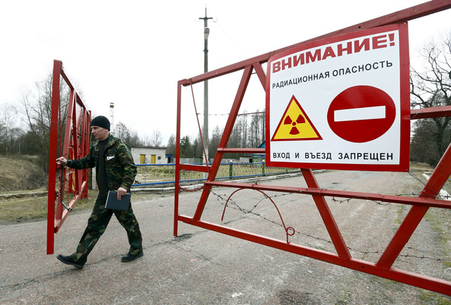 an employee opens the gate at the checkpoint quot maidan quot in the 30 km 19 miles exclusion zone around the chernobyl nuclear reactor near the abandoned village of babchin belarus march 11 2016 photo reuters