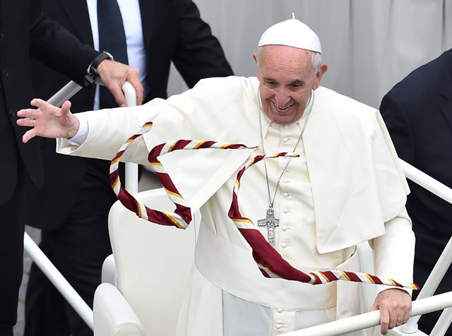 catholic scouts throw their scarfs to pope francis as he greets the crowd after a mass for the youth day of the jubilee year on april 24 2016 at st peter 039 s square in vatican photo afp