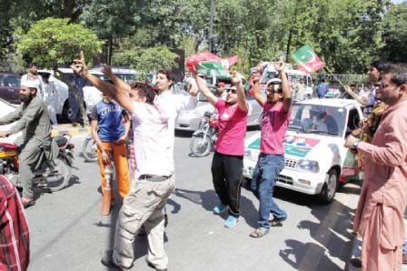 women activists pose for the camera as they get set for their journey to islamabad l men dance to the tune of music near nasser bagh photo abid nawaz express