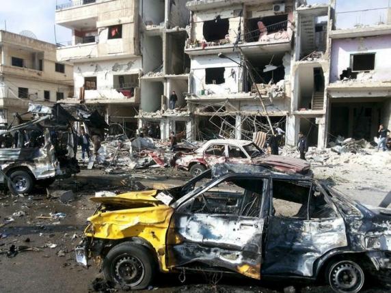 people inspect the site of a two bomb blasts in the government controlled city of homs syria in this handout picture provided by sana on february 21 2016 photo reuters
