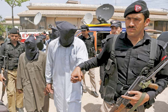 police escort men arrested in connection with the killing of sikh politician soran singh after they were presented to the media at a news conference in peshawar photo reuters police escort men arrested in connection with the killing of sikh politician soran singh after they were presented to the media at a news conference in peshawar photo reuters