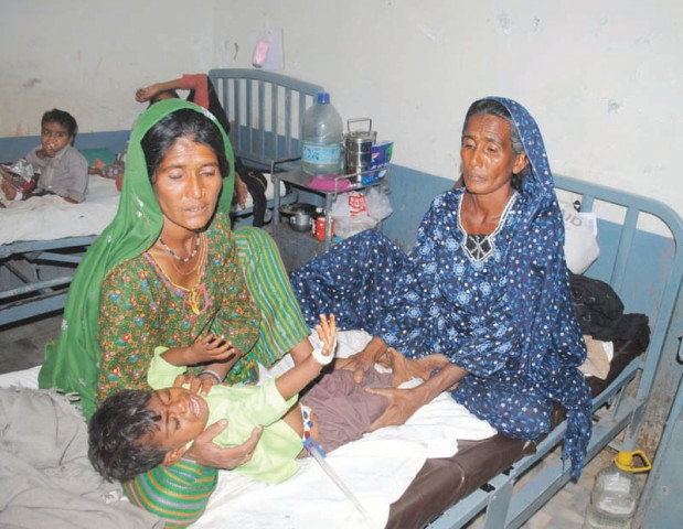 women tend a child suffering from malnutrition at mithi hospital in tharparkar photo file women tend a child suffering from malnutrition at mithi hospital in tharparkar photo file