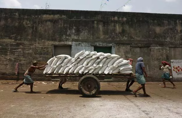 labourers push a handcart loaded with sacks of sugar at a wholesale market in kolkata india april 26 2016 photo reuters labourers push a handcart loaded with sacks of sugar at a wholesale market in kolkata india april 26 2016 photo reuters