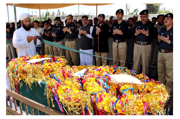 police officials and others are offering fateha during the funeral of asi qaiser shah at yakatoot photo inp